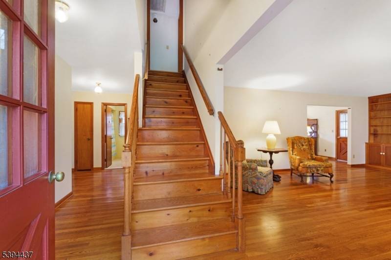 Nestled in a premium location in Martinsville on a cul de sac overlooking a private treed backyard and stream, this spacious expanded ranch offers a versatile floor plan.