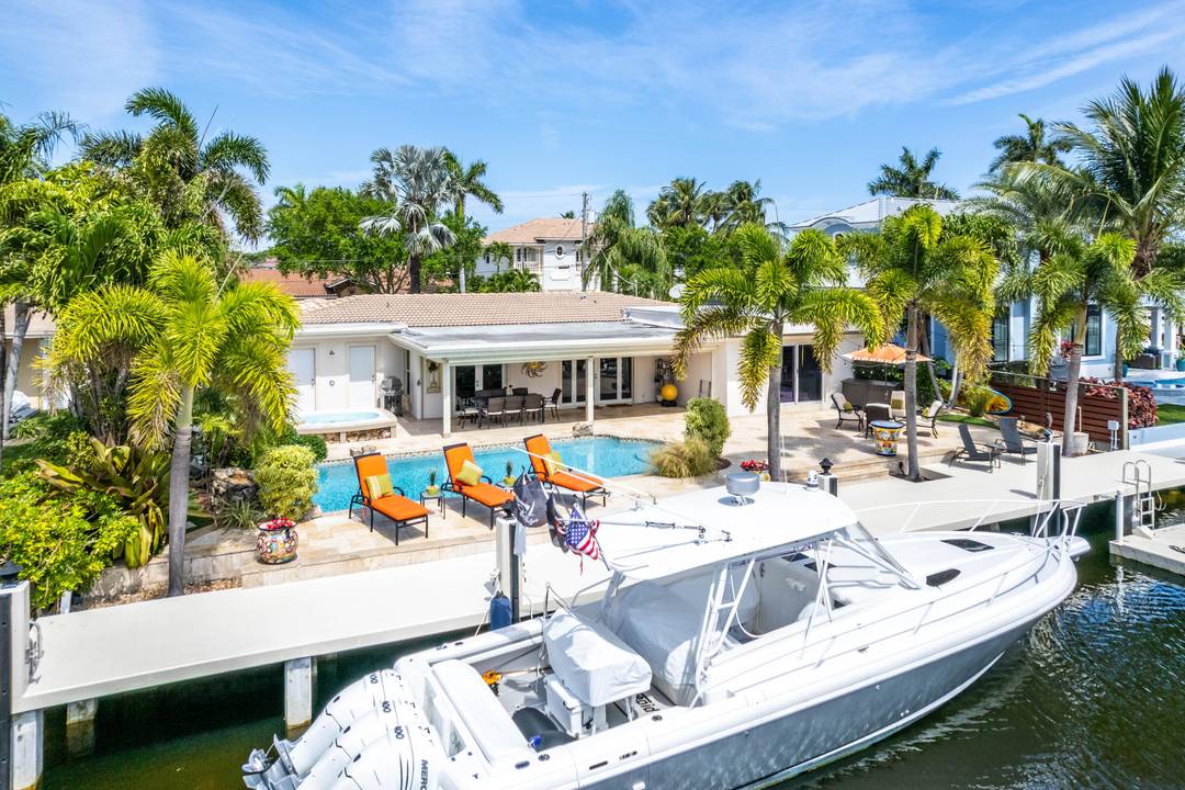 Intracoastal dream home with a Sunny backyard facing South, featuring a heated pool, spa, BBQ, outdoor kitchen and 3 bathrooms plus a Cabana bathroom.