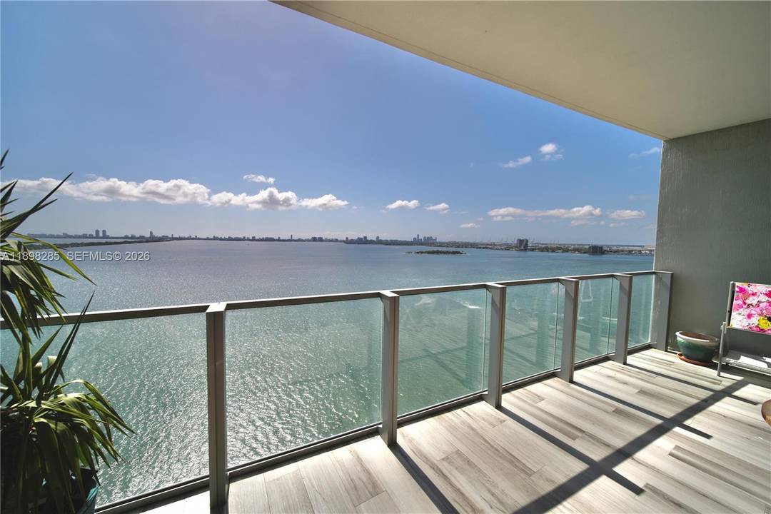 Stunning 2BD DEN 3BA residence at Biscayne Beach with private elevator entry and sweeping bay views from both bedrooms and the living area.