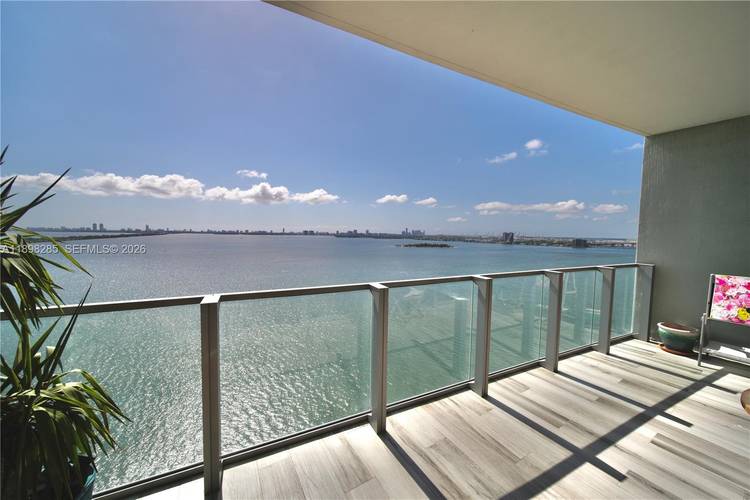 Stunning 2BD DEN 3BA residence at Biscayne Beach with private elevator entry and sweeping bay views from both bedrooms and the living area.