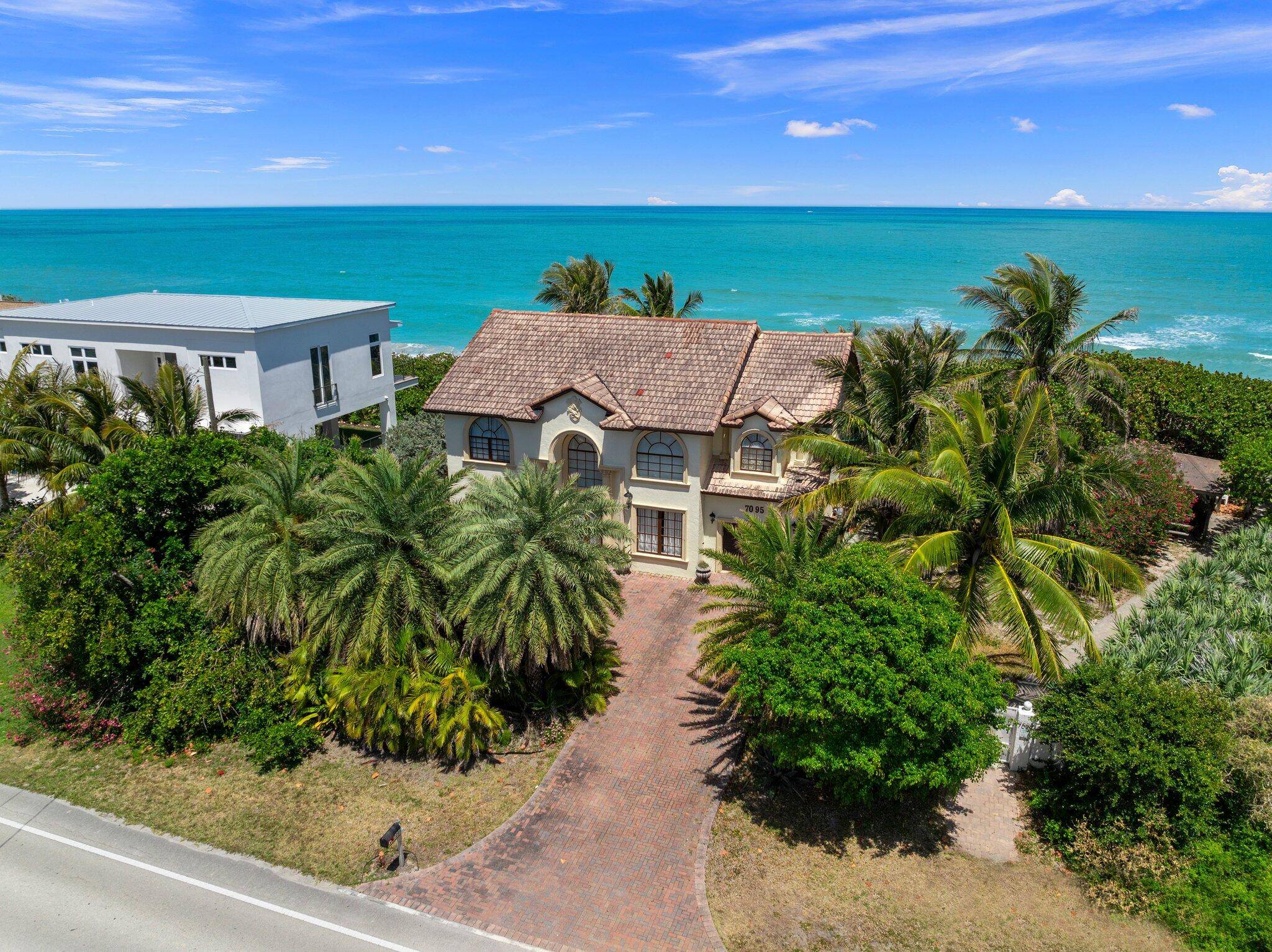 Discover unparalleled coastal luxury at this stunning oceanfront estate, nestled on a lush half acre beside a serene nature preserve no HOA.