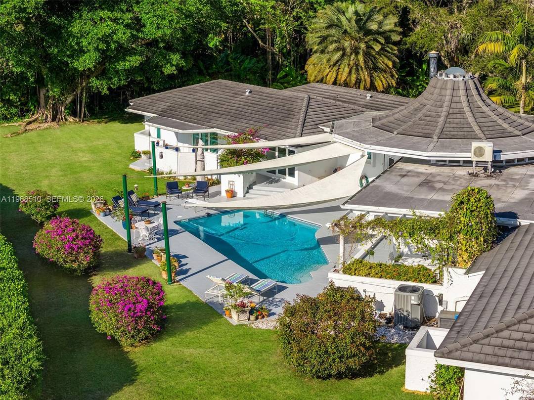 Set on a premier builder s acre in the heart of Pinecrest, Florida, this striking canal front estate is a rare blend of architectural pedigree, thoughtful updates, and timeless design.