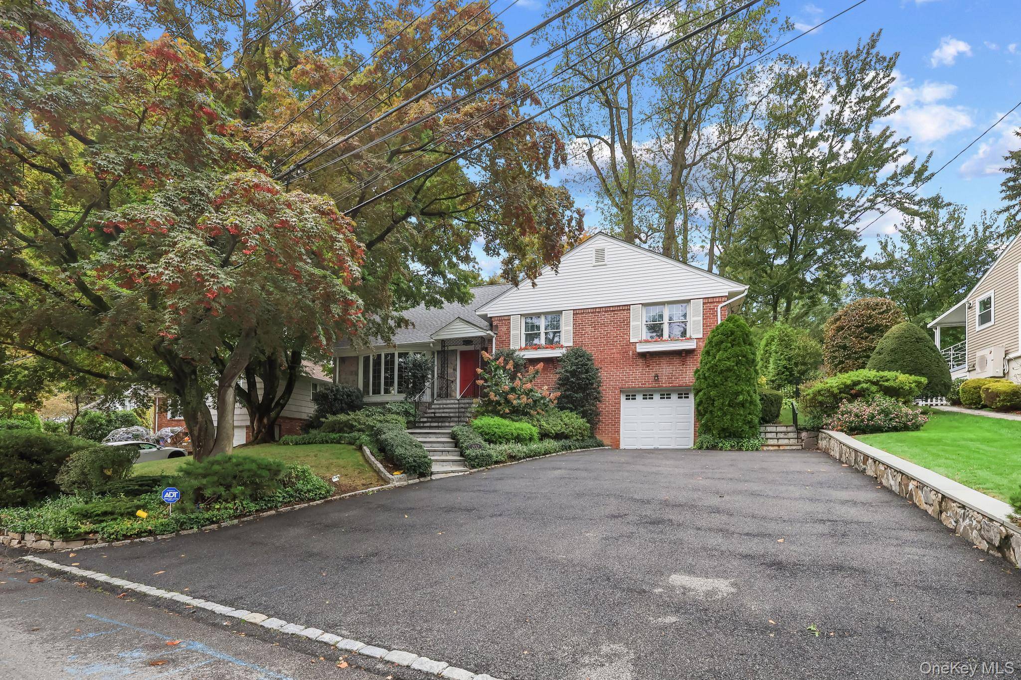 Welcome to 202 Old Wilmont Road, a wonderful split level ranch with wood floors throughout, a living room with a cozy gas fireplace, and manicured plantings in the back yard.