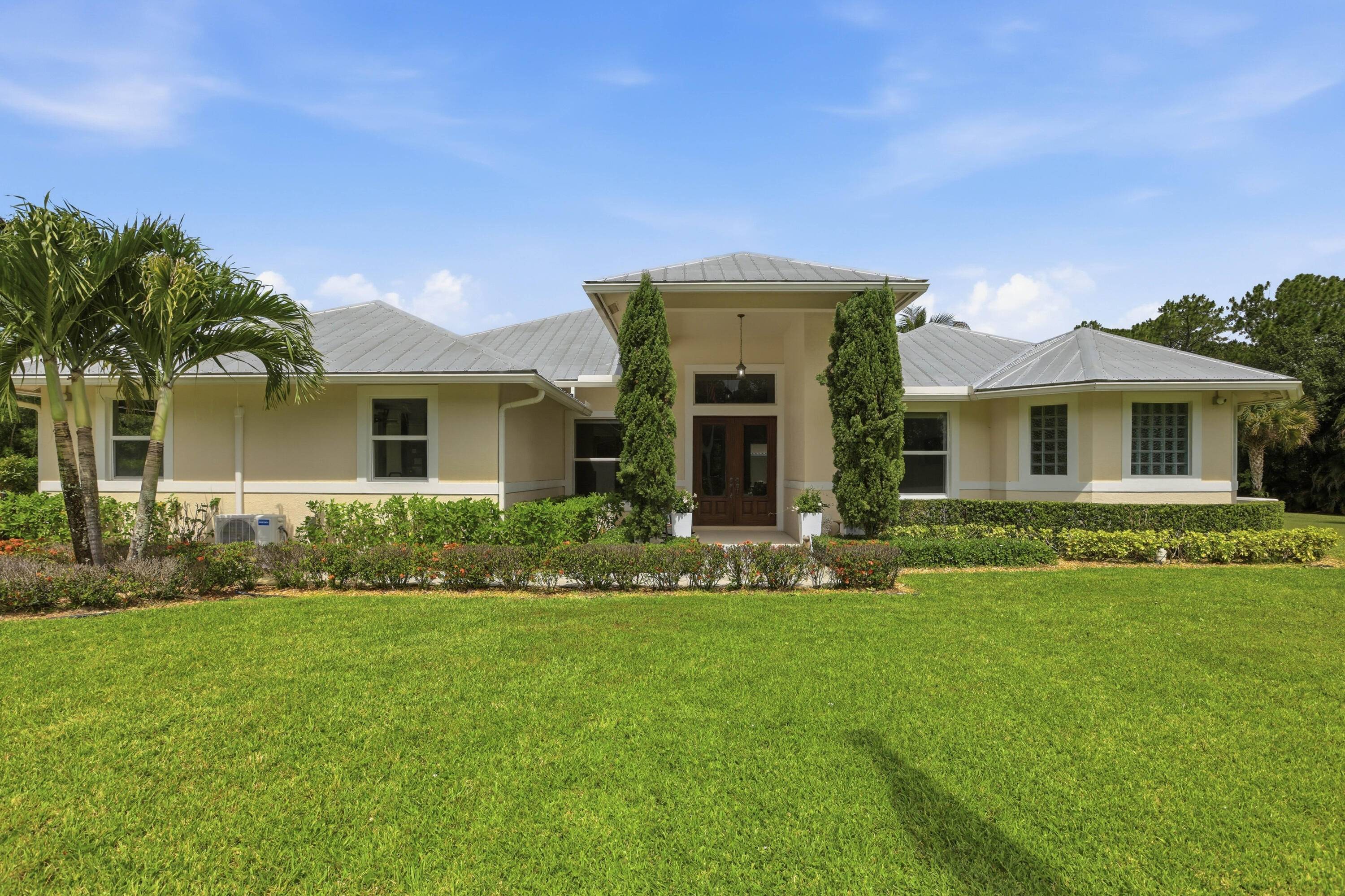 Escape to the tranquility of Jupiter Farms on this exceptional 5 acre equestrian property featuring a beautifully appointed main residence, detached guest house, and a 3 stall barn with five ...