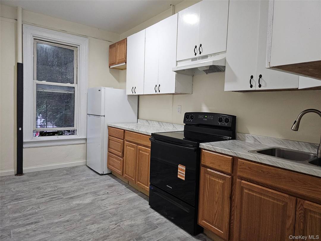 Multi family home in the Fordham section features one 4 bedroom apt and two 3 bedroom apts with an unfinished walkout bsmt.