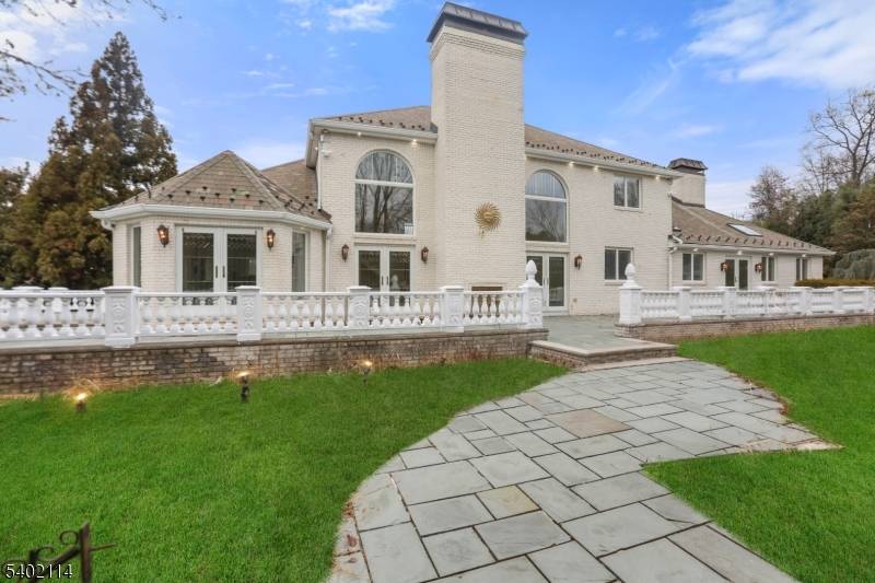 Exceptional luxury residence located on one of Florham Park's most desirable streets, set on a quiet cul de sac with a striking black gated entrance.