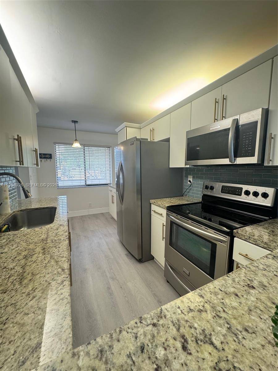 3 bedroom, 2 bath corner unit in the highly desirable Racquet Club at Bonaventure, Weston.