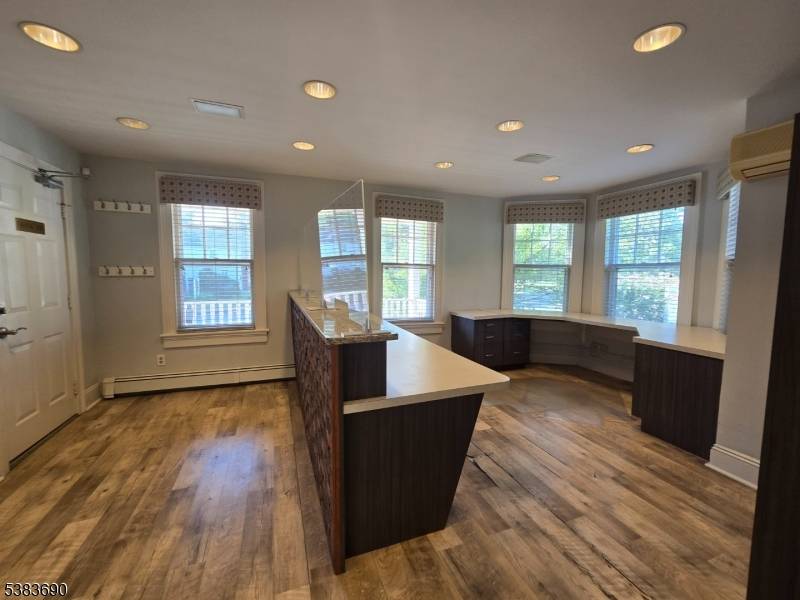 Prime commercial space on 1st Floor, 1 bedroom apt on 2nd floor and 3 garage bays.