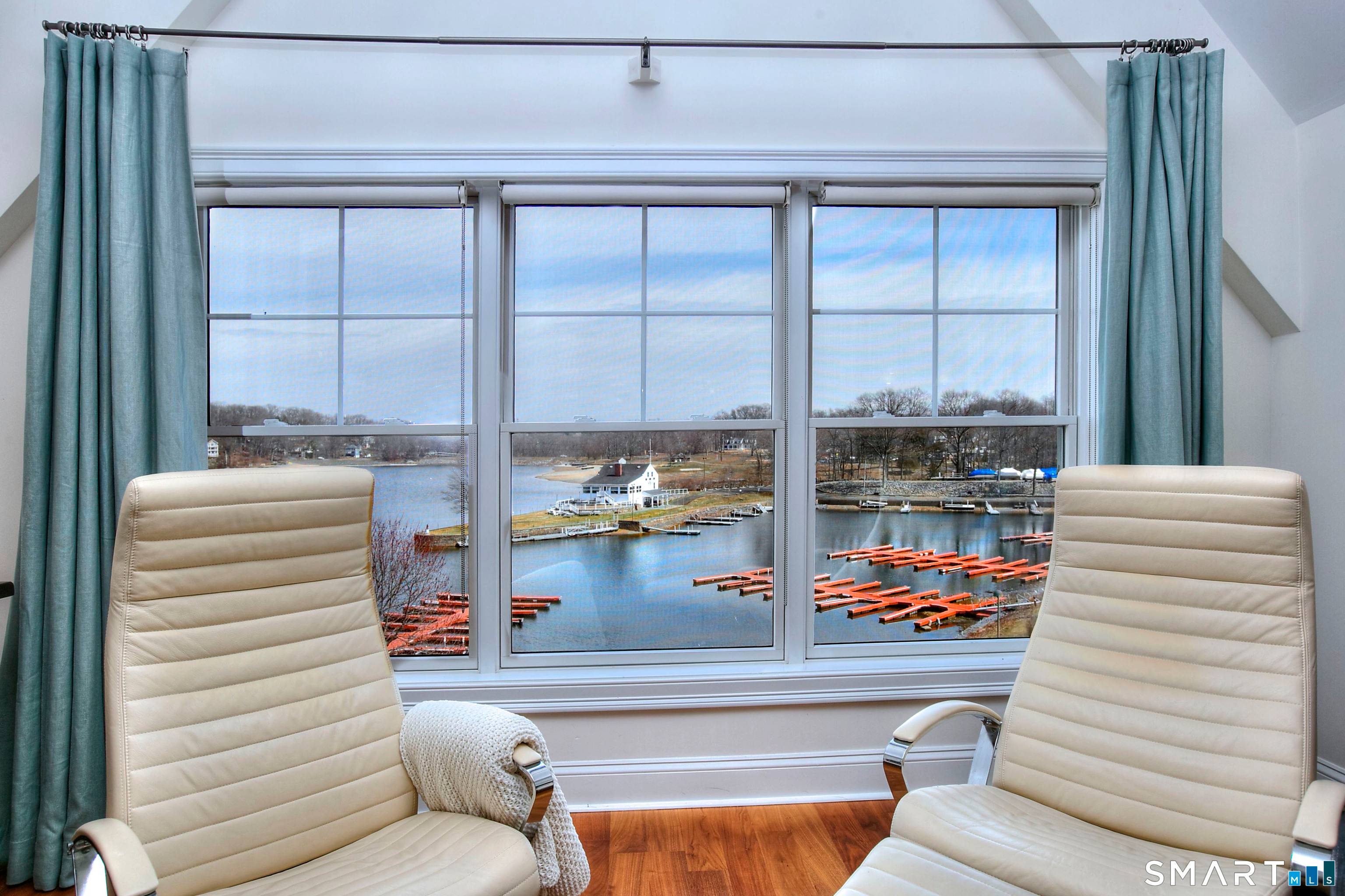 Experience elevated lakeside living in this stunning two level penthouse overlooking Candlewood Lake.