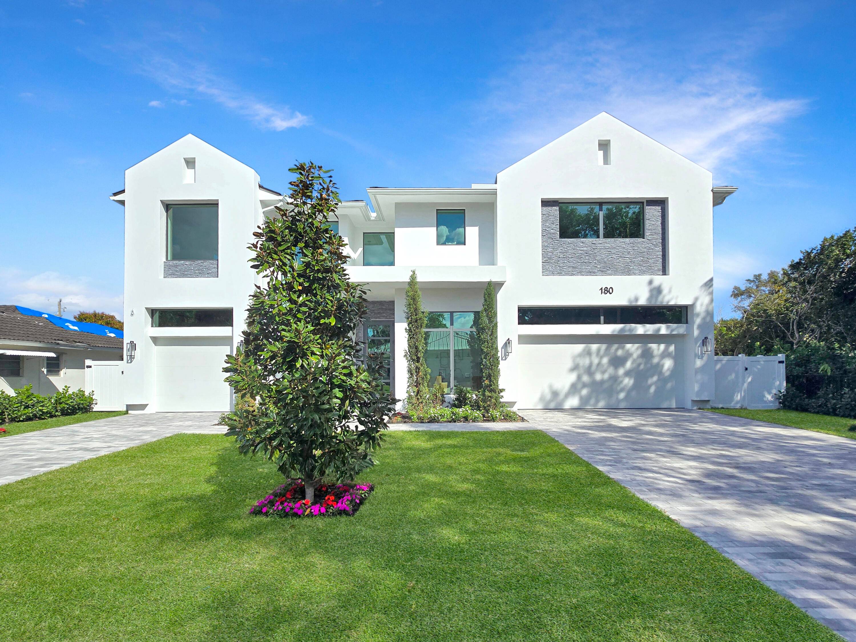 Experience the pinnacle of modern farmhouse living in this extraordinary residence by Mizner Development, where expansive open spaces seamlessly blend with the finest designer finishes and features.