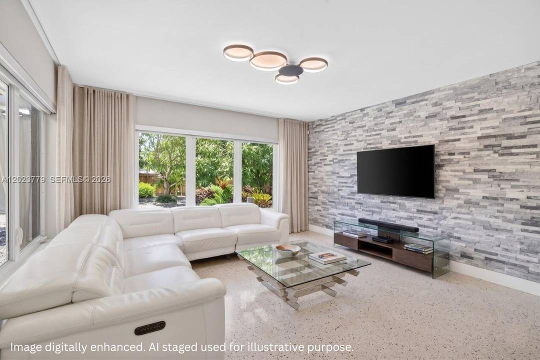 Renovated split floor plan home in Hallandale Beach with terrazzo floors, FULL IMPACT WINDOWS amp ; DOORS and a ELECTRIC STONE SURROUND FIREPLACE.