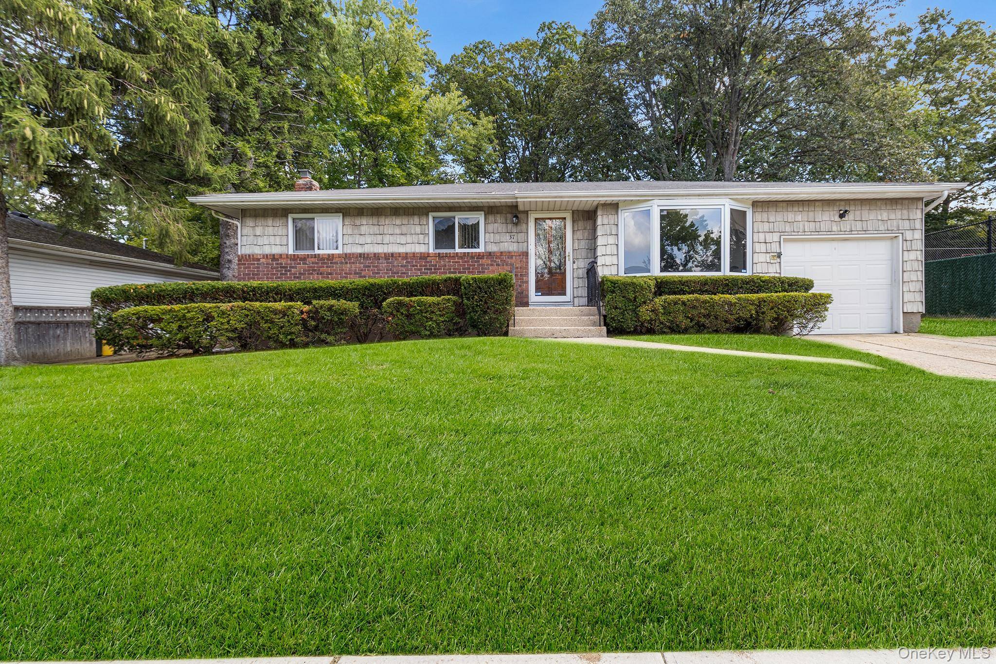 Welcome to 37 Beaumont Drive, a beautifully maintained Ranch style home nestled in the heart of Plainview.