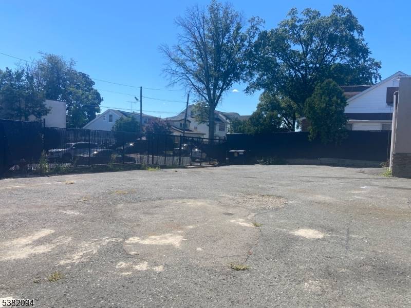 One level commercial building with 3 doors, high ceiling, office with bathroom.