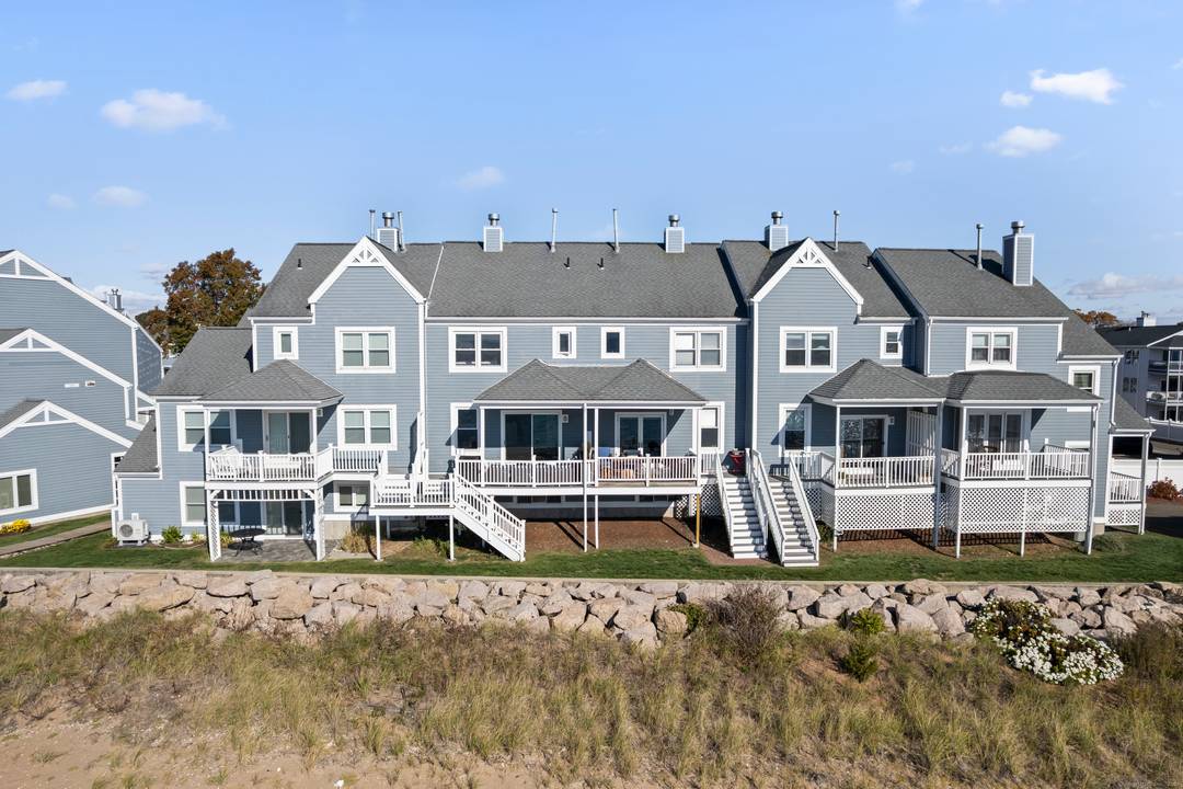 Beautifully renovated waterfront townhouse offering beach access, stunning water views from virtually every room, a versatile bonus room, and an attached garage with additional storage.