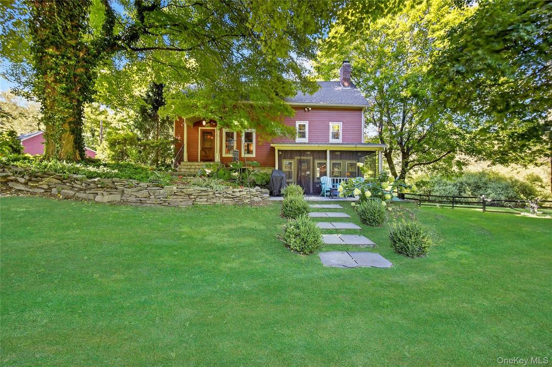 Nestled amidst a vibrant embrace of mature trees and lush plantings, discover this beautifully restored and expanded 1788 Farmhouse.