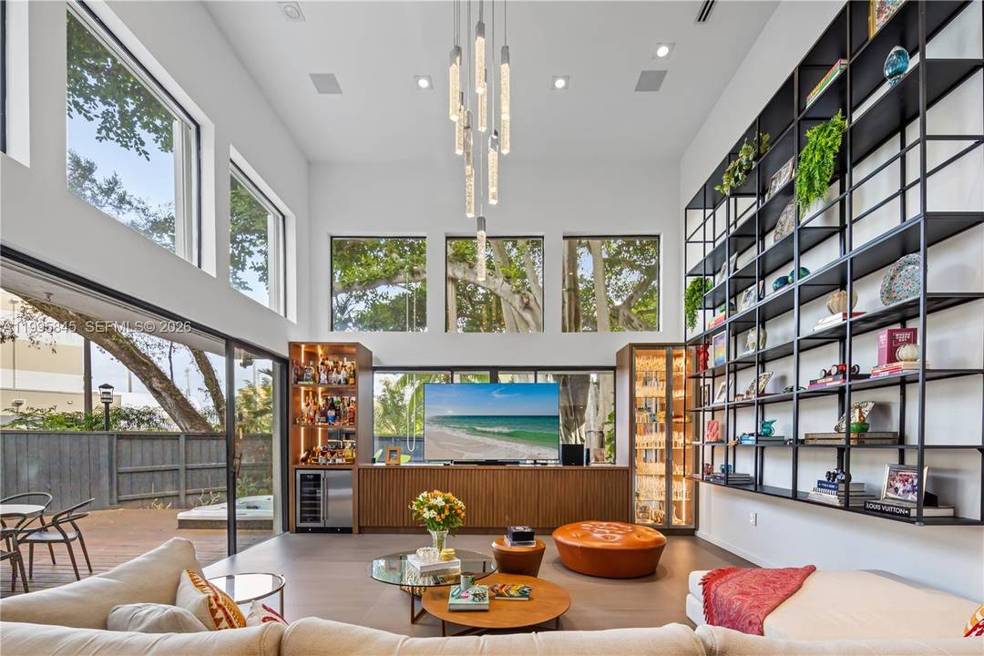 Discover a rare opportunity to live in the gated enclave of Kumquat Village, nestled in the heart of South Coconut Grove.