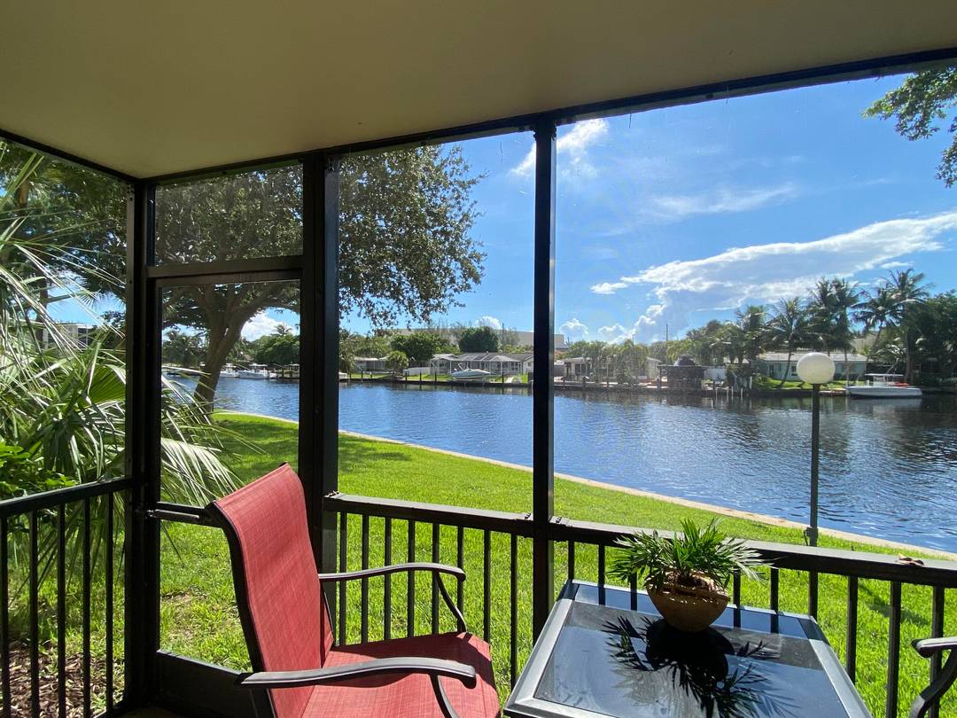 Wake up to breathtaking Hillsboro Canal views from this beautifully updated end unit condo in Boca Bayou, a sought after gated boating community in the heart of Boca Raton.