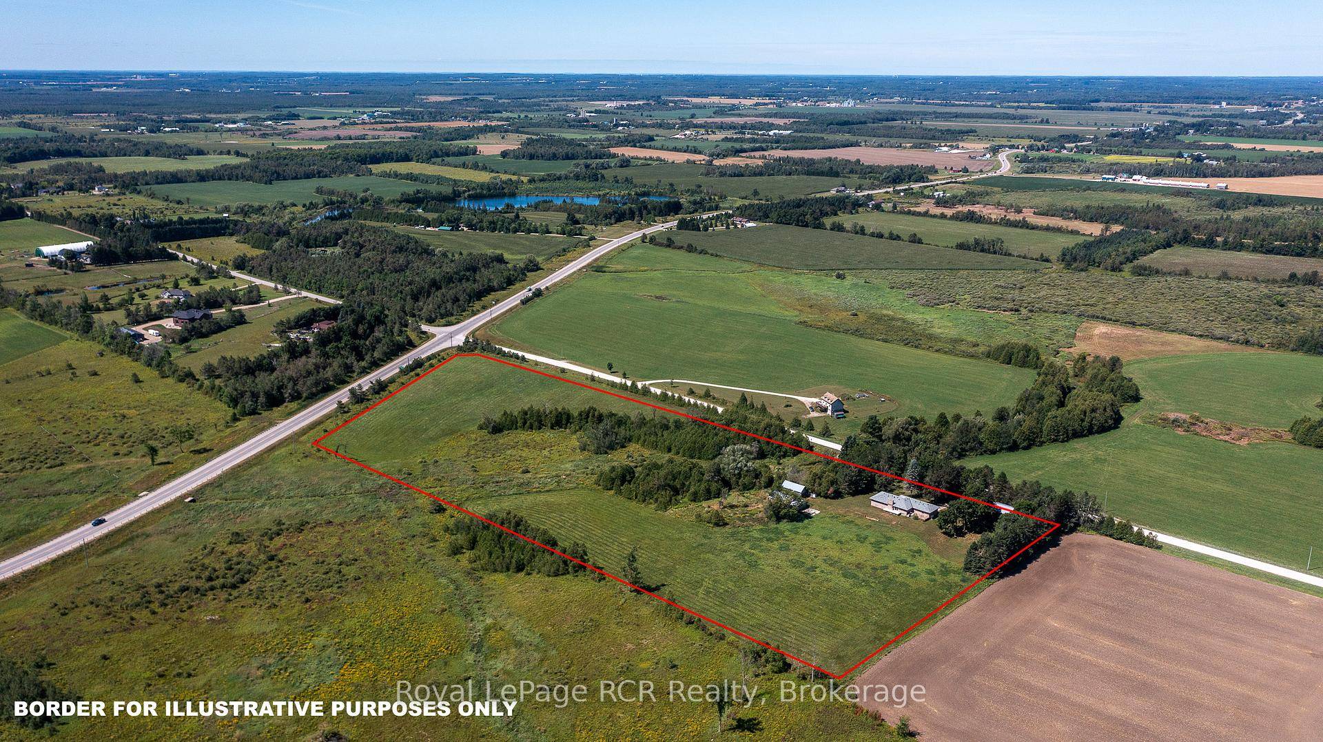 Brick bungalow with attached garage, 30x50 shop and a small barn on 16 acres.