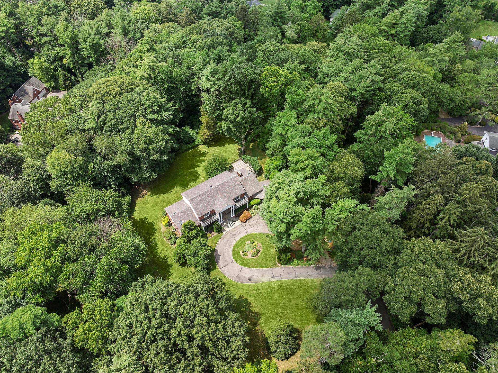 Tucked away on a quiet and private street in the village of Old Brookville, this modern Colonial sits on 2.