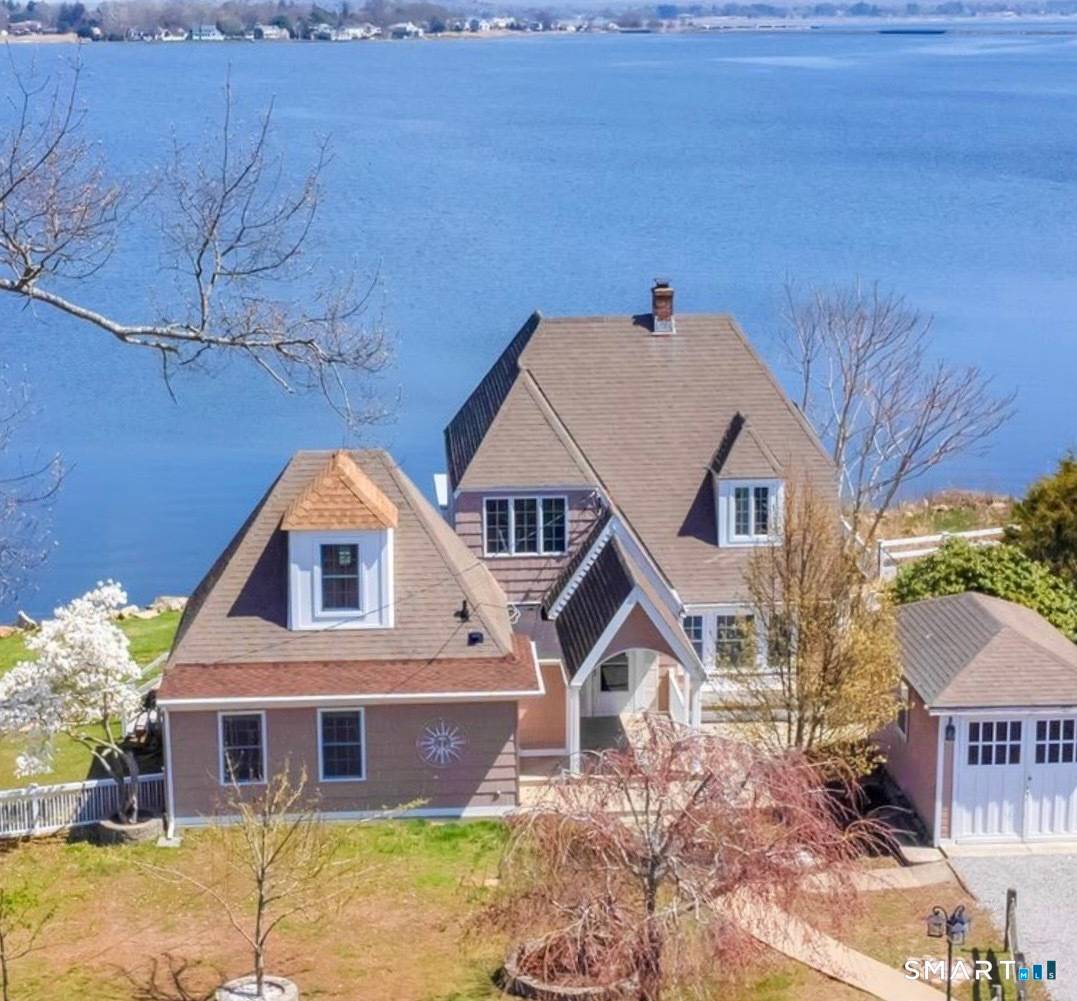 Nestled on the waterfront in the highly sought after South Cove, this Knollwood Beach property offers sweeping panoramic views from every room.