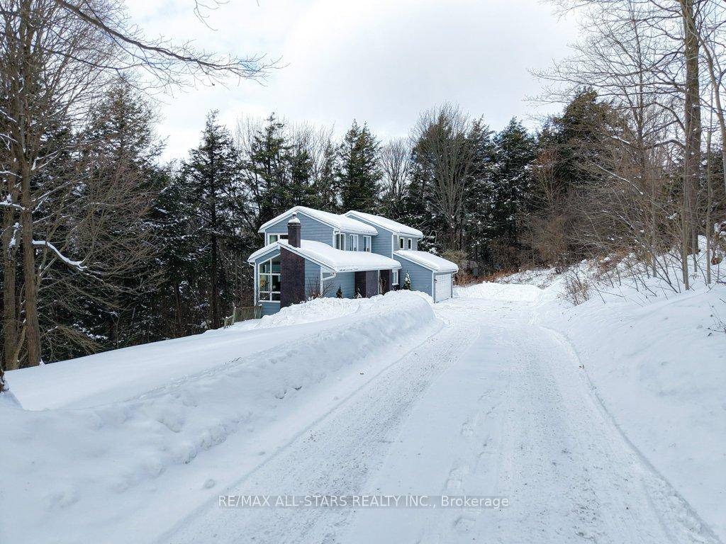 Nestled within a vibrant forest and less than five minutes from town, this custom designed home offers a perfect blend of natural beauty and modern convenience.