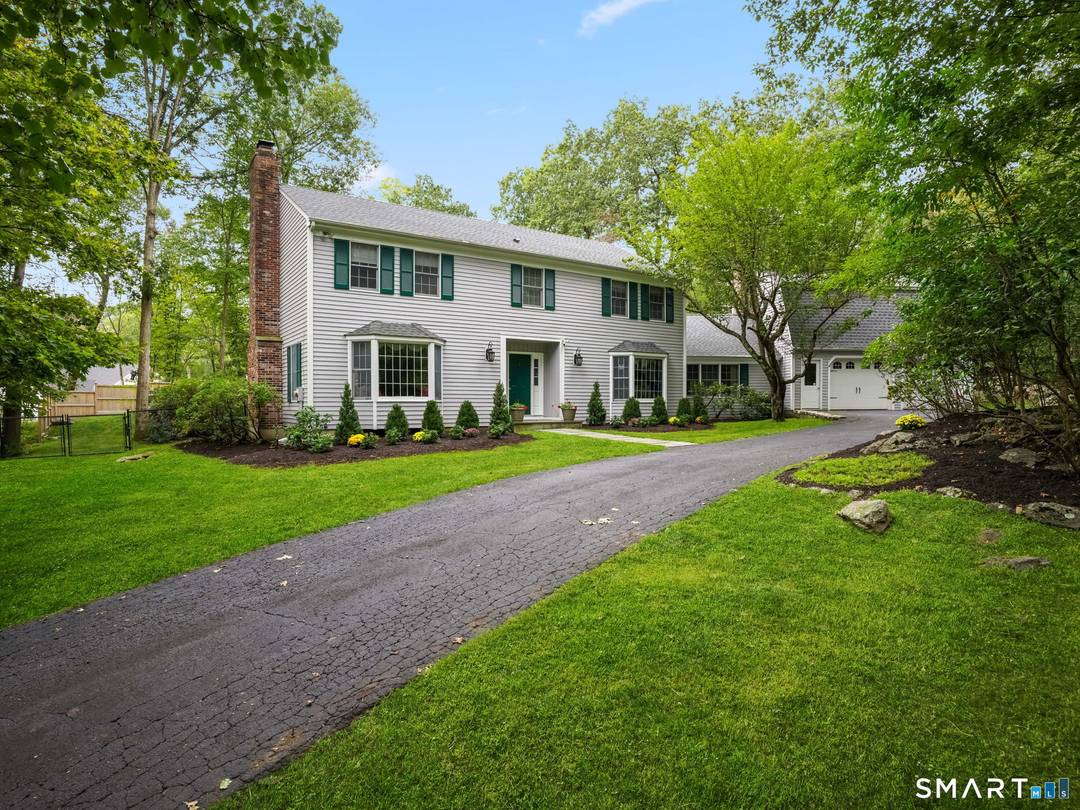 Ideally situated in southern Wilton near the New Canaan border, this beautifully appointed four bedroom, 2.