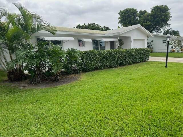Beautifully updated Regis Model on a generous corner lot in Leisureville, providing enhanced privacy and featuring five fruit trees, including an inviting outdoor patio shaded by a Longan tree.