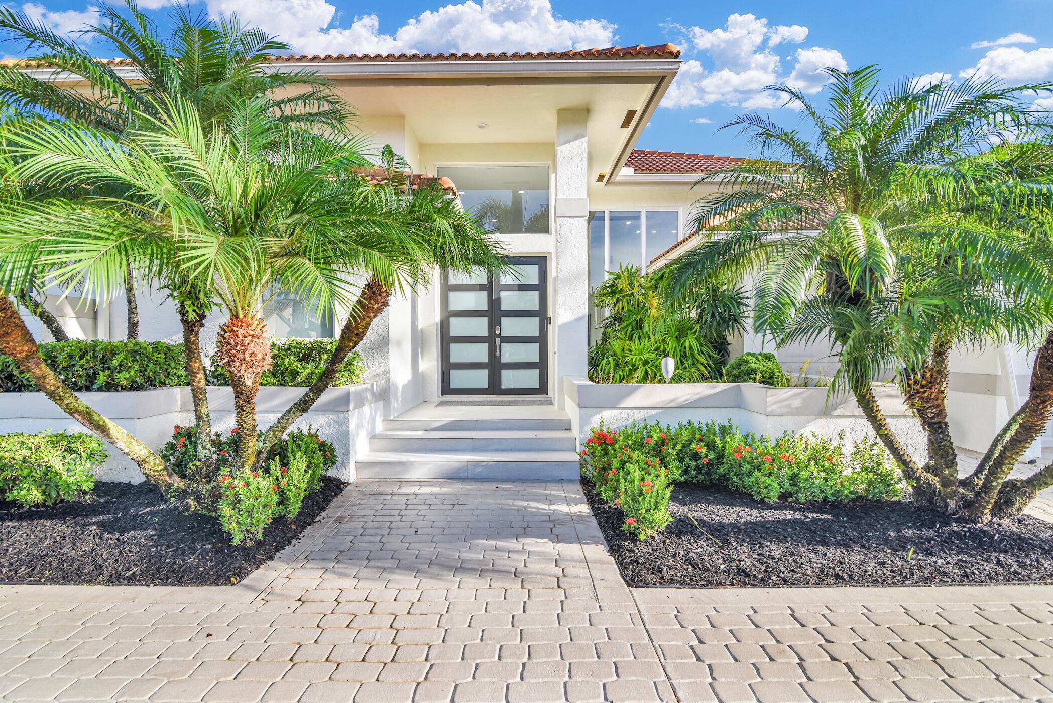 Thoroughly and thoughtfully renovated over a two year period, this extraordinary property wasdeveloped by one of Boca's premier designer builders, and transformed into an oasis of modernliving.