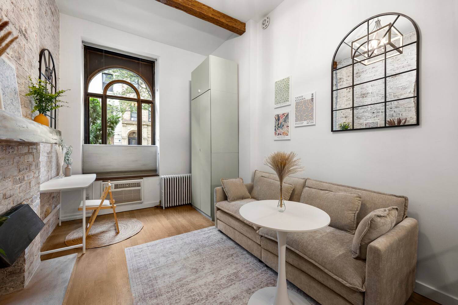 Barn doors, soaring ceilings, arched windows, exposed brick, and muted sage.