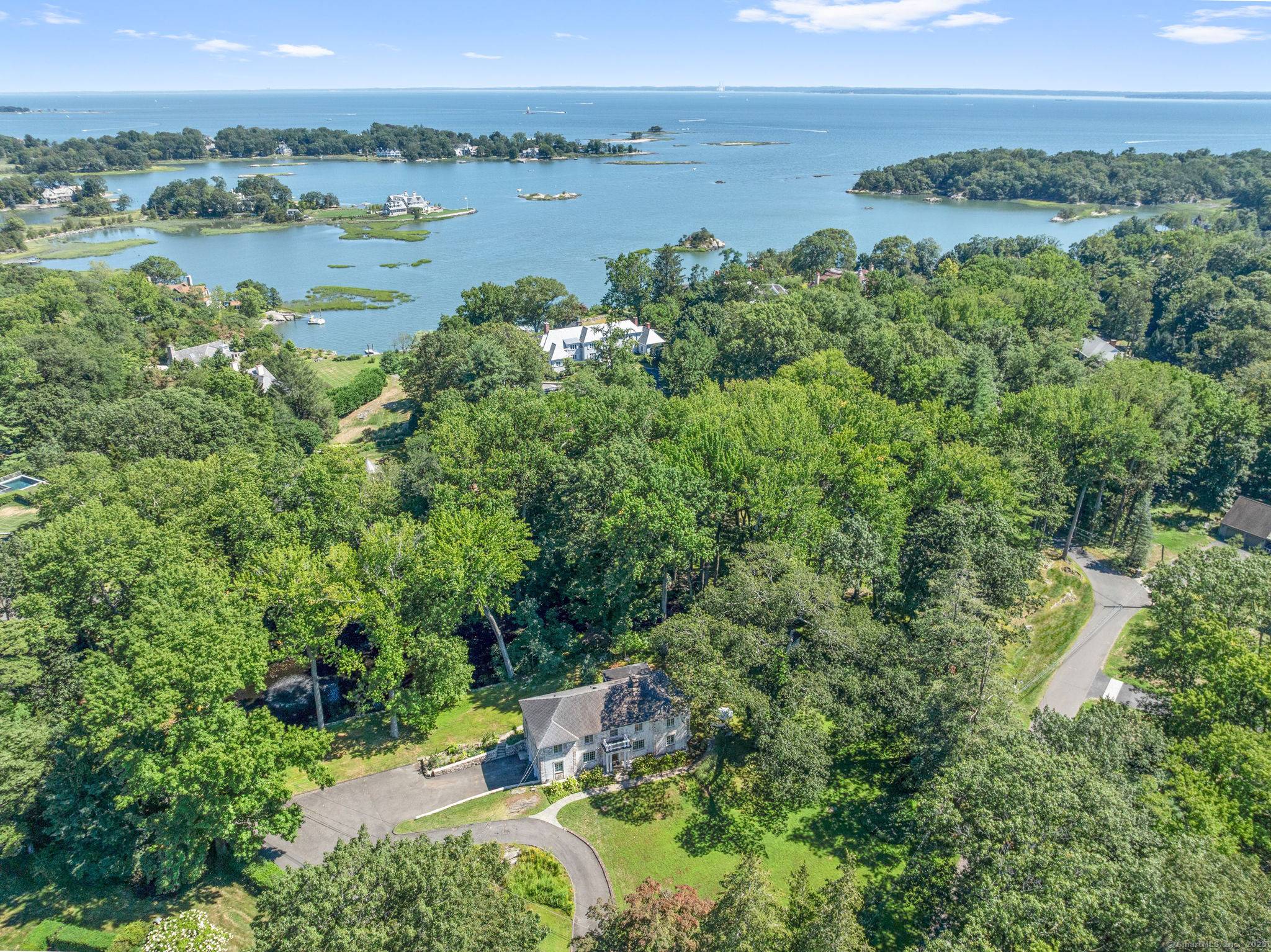 Nestled within the highly sought after Delafield Island Association, 46 Sunswyck Road is a distinguished brick estate set on 1.