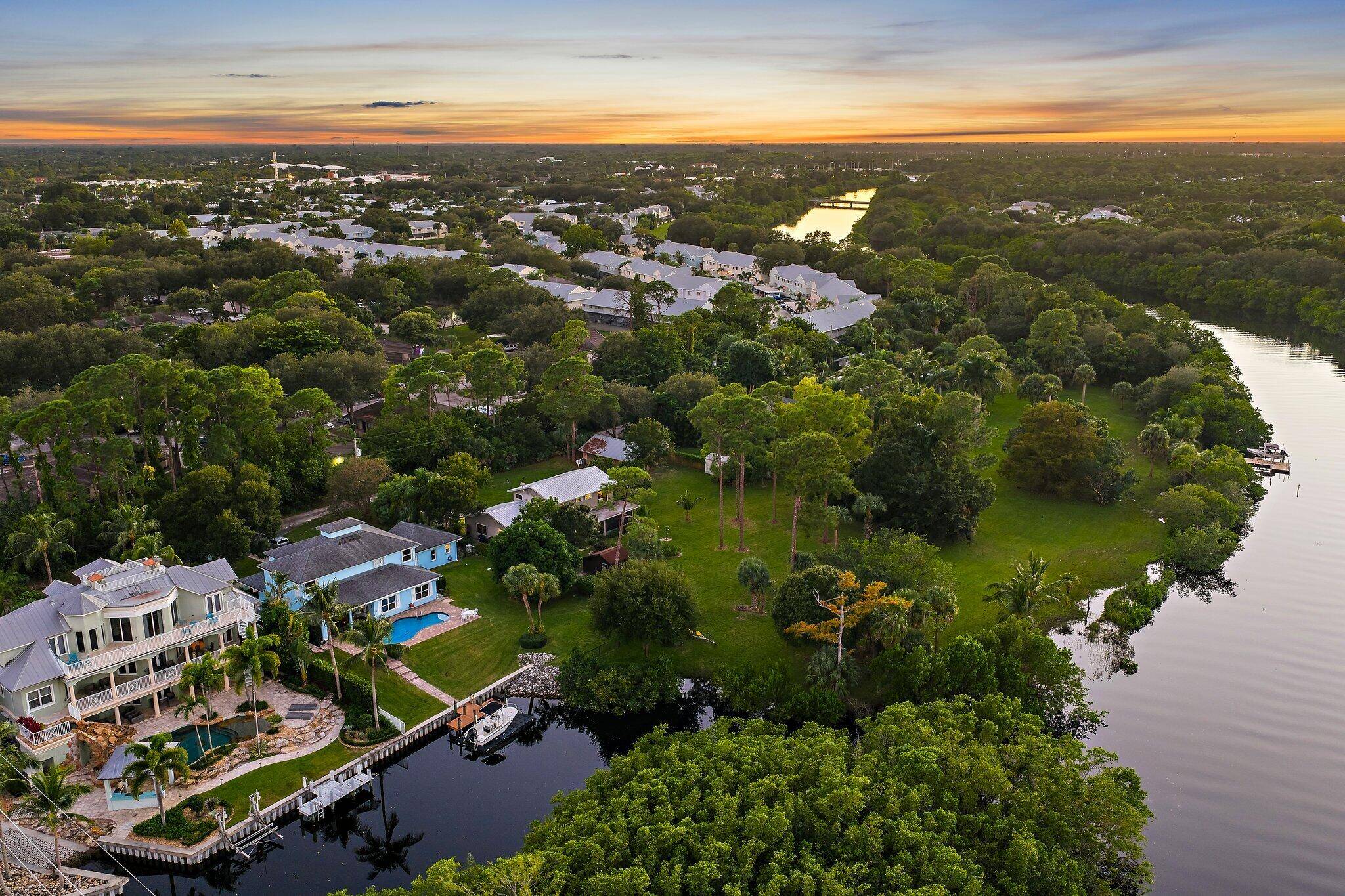 Tucked away on one of Jupiter's most private, little known streets, this half acre waterfront property captures the quiet beauty of Old Florida.