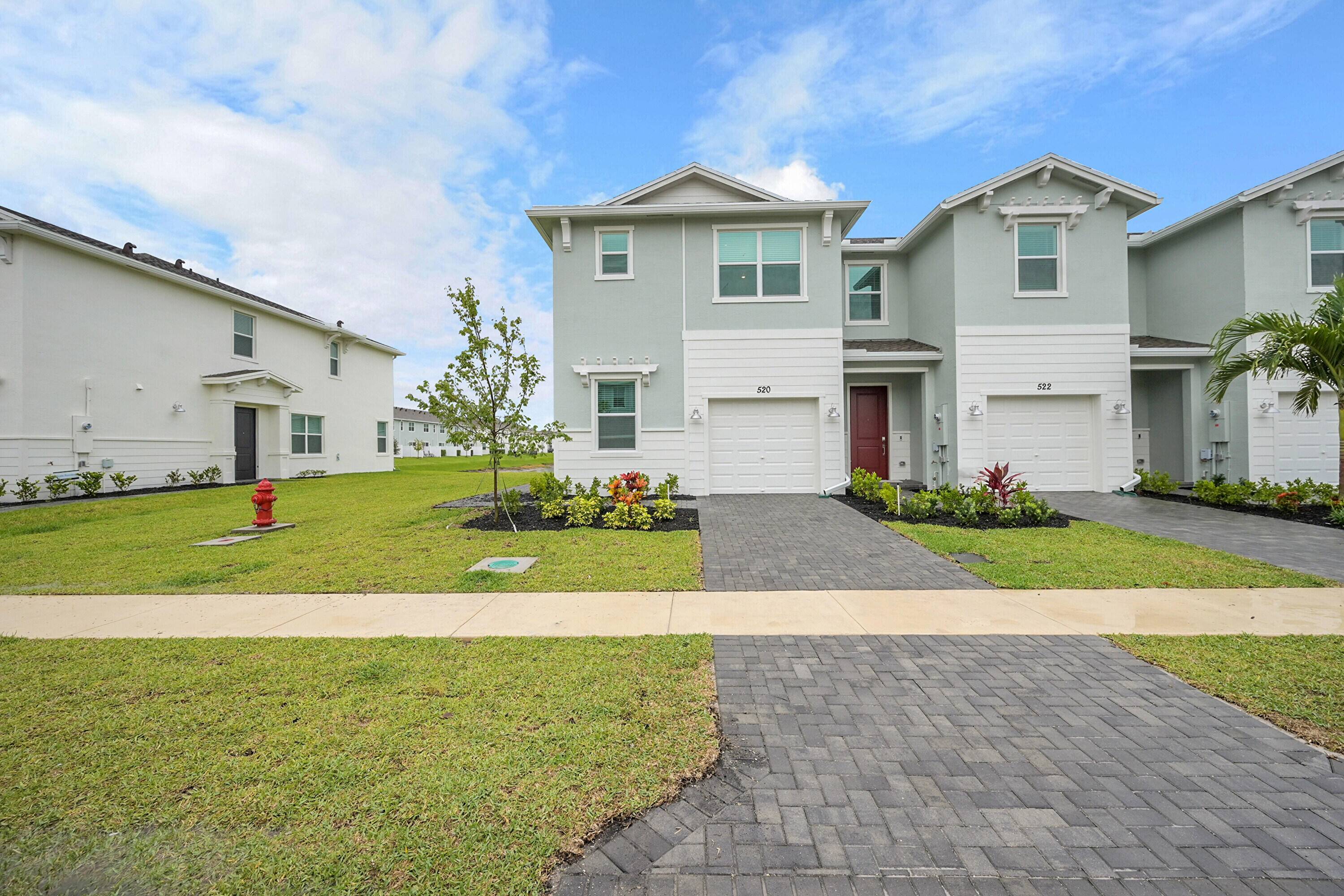 This two story townhome showcases a contemporary open design among the first floor kitchen, dining room and living room to promote seamless transitions between spaces.