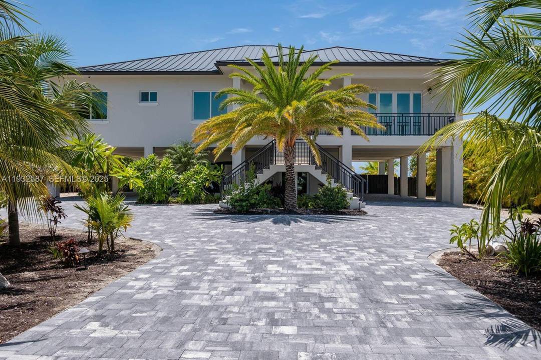 Nestled on the exclusive, gated island of Sunrise Isles in Marathon, Florida Keys, this magnificent new construction oceanfront estate redefines luxury living.