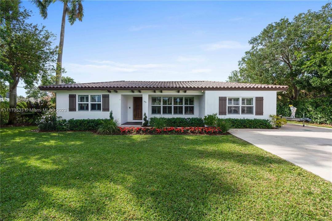 Beautifully landscaped corner DOUBLE lot w mature oaks, palms ; full clusia hedge.
