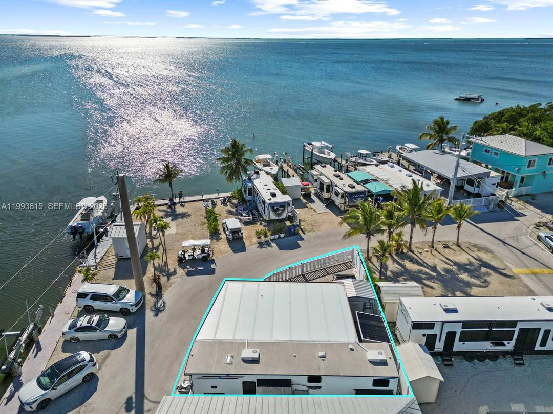 Oversized corner lot in Calusa Campground offering 1, 000 sq ft more than standard lots with partial bay and canal views.