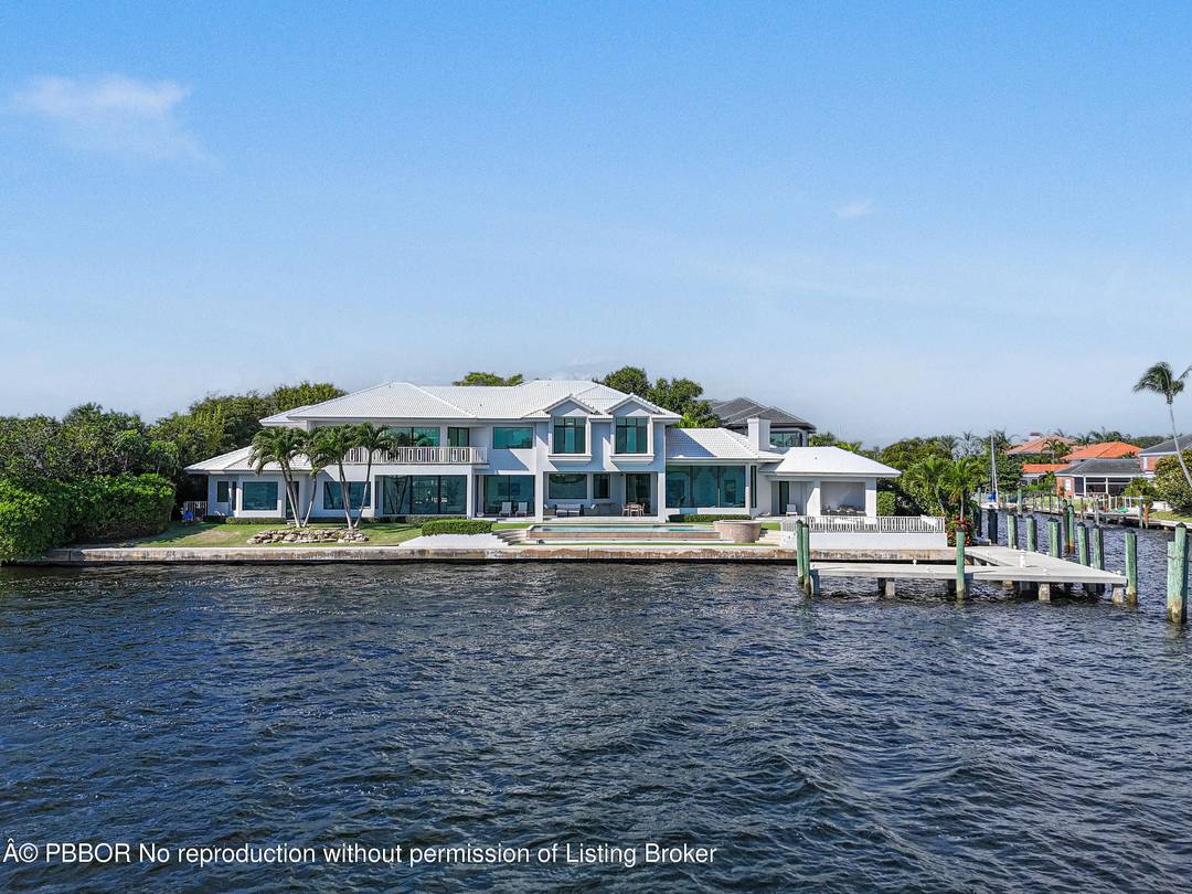 Experience the pinnacle of waterfront luxury with this exceptional estate, offering sweeping 180 panoramic views of MacArthur State Park, Munyon Island, and Singer Island.