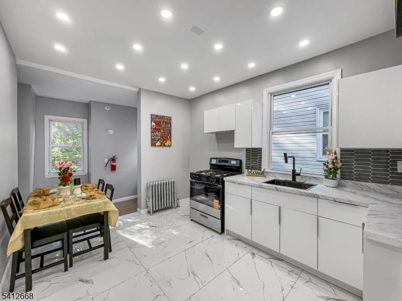 OPPORTUNITY AWAITS ! Ideal for both investors and owner occupants, this expansive two family home has been meticulously transformed with modern amenities and finishes.