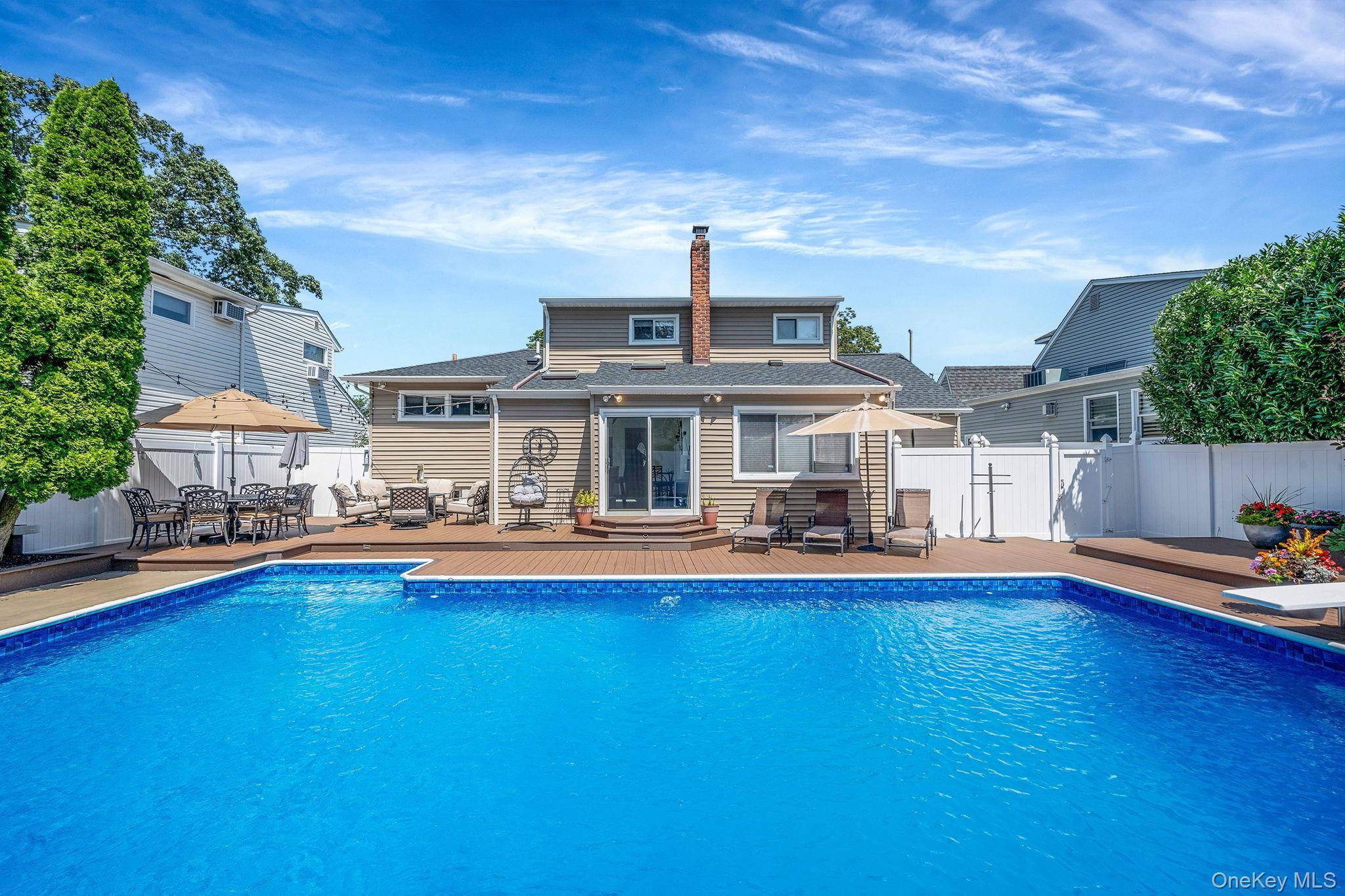 Welcome to Massapequa Park s entertainer s dream home a rare blend of style, comfort, and outdoor living.