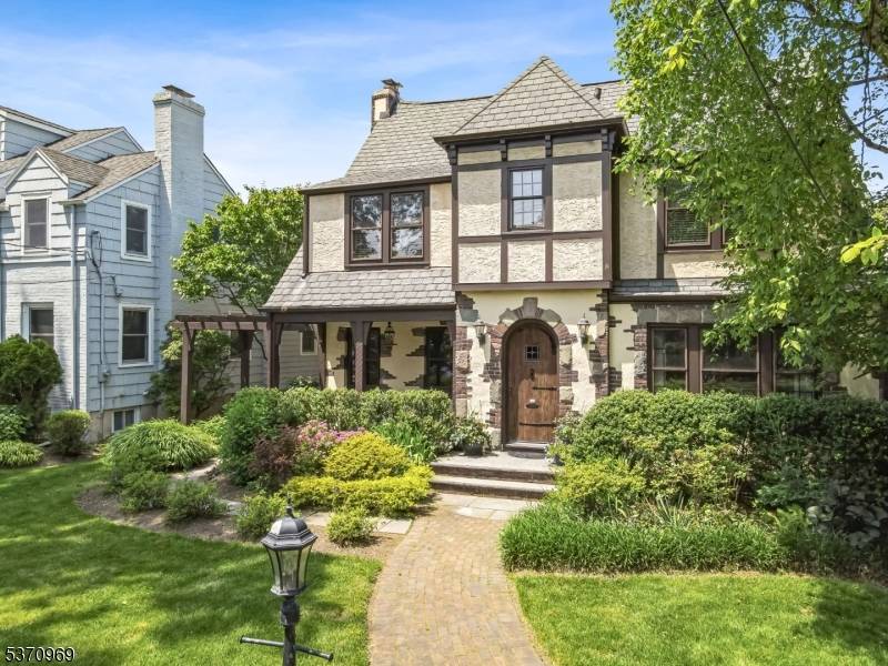 Discover enchanting elegance in this Tudor style colonial, a home that combines classic charm w modern luxury.