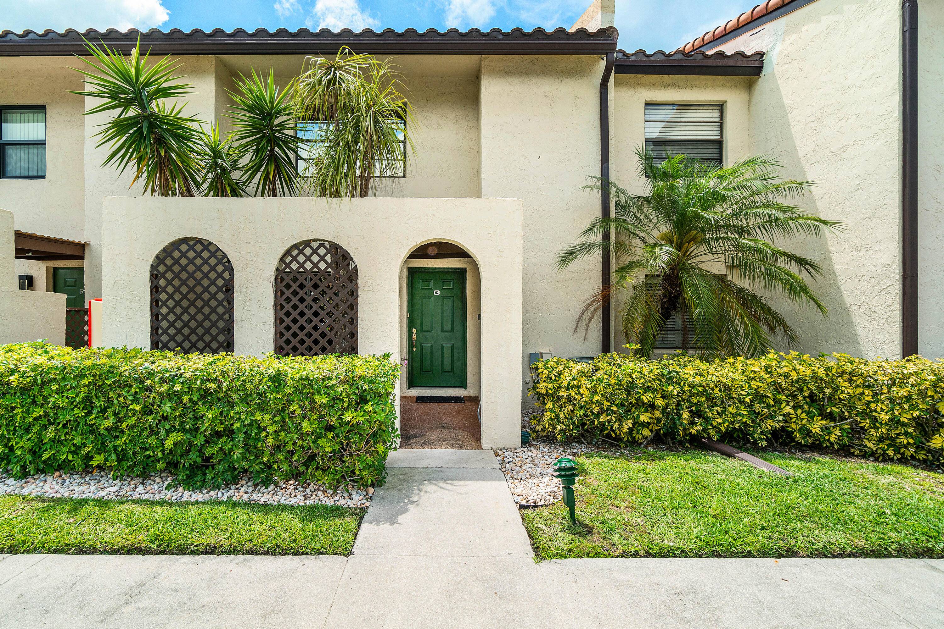 Discover this stunning renovated townhome style residence with amazing lake views located within the gated membership optional 55 country club community of Boca Lago.