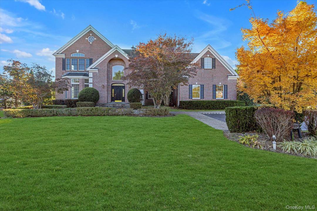 Elegant Colonial with a stately brick facade located within the prestigious, 24 hour gated community of Country Pointe in Dix Hills.