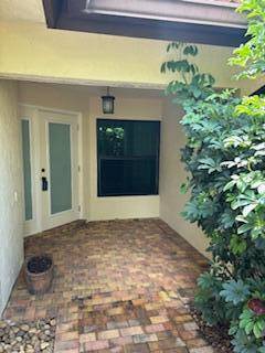 3 2 home in Central Boca with covered Patio and Private Pool, fenced in yard on a corner lot.