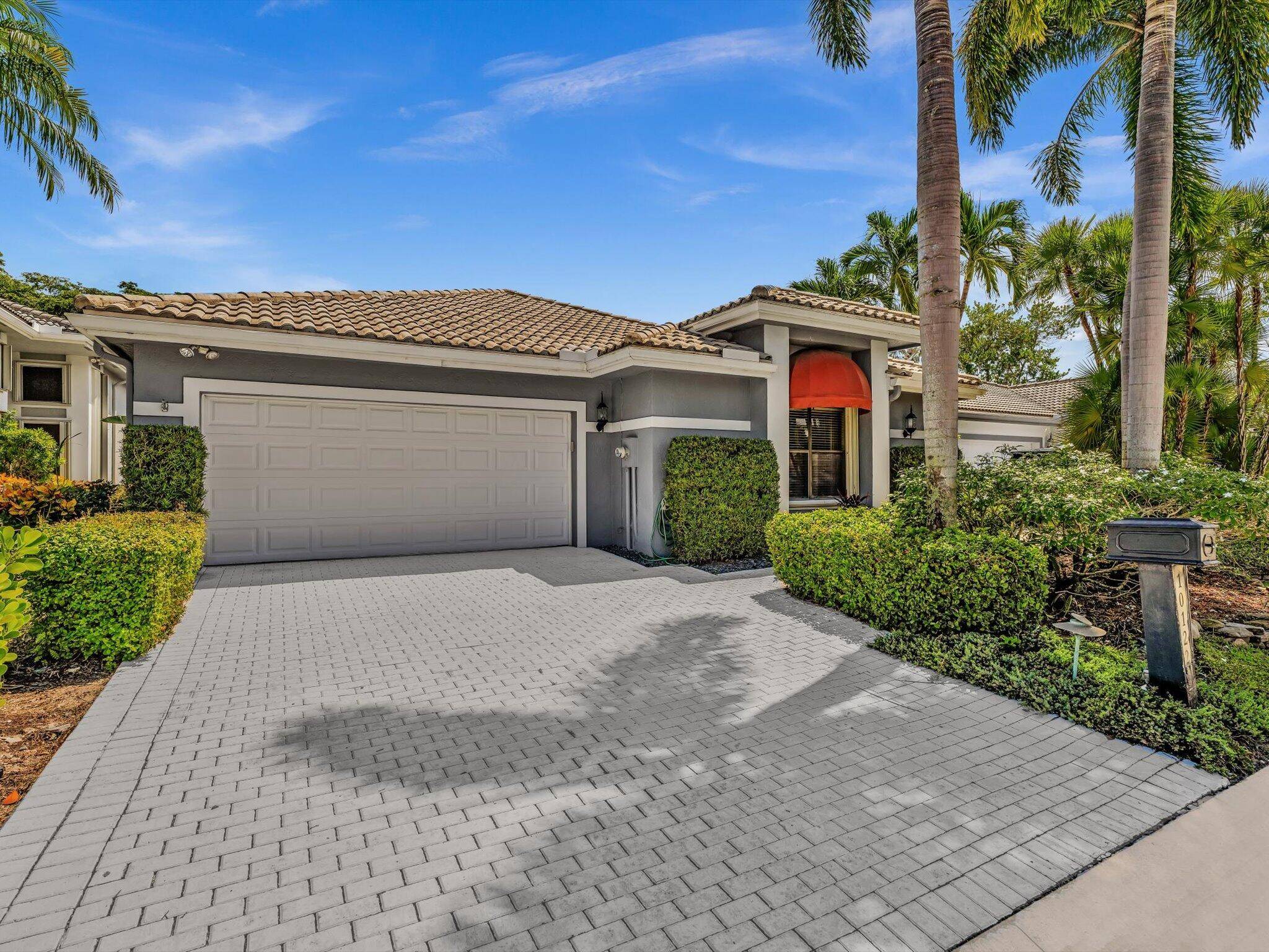 Step into this Stonebridge Country Club home with soaring ceilings and one of the most beautiful lake views from the kitchen, living room, and primary bedroom.