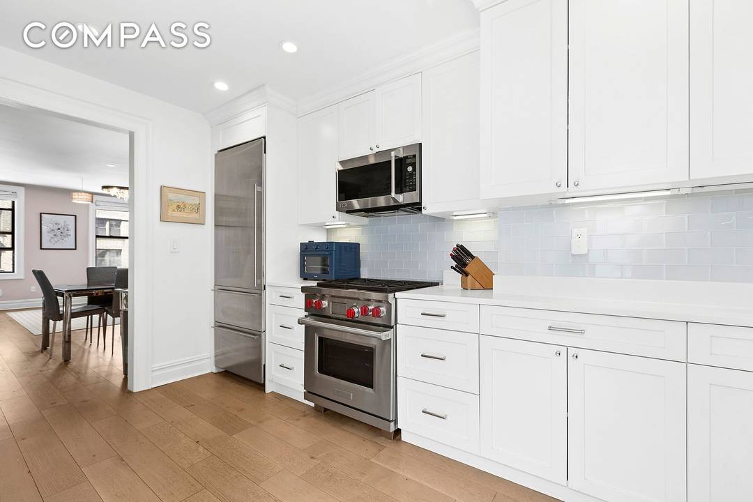 This beautifully renovated two bedroom, two bath has a huge windowed kitchen and gets tons of light through its many windows perched above neighboring brownstones.
