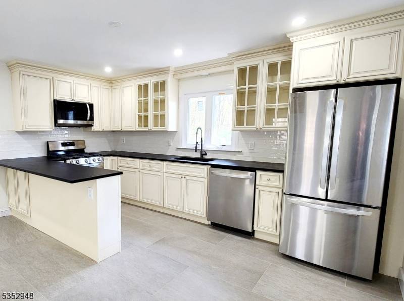 Welcome to this freshly renovated brick cape with versatility galore.