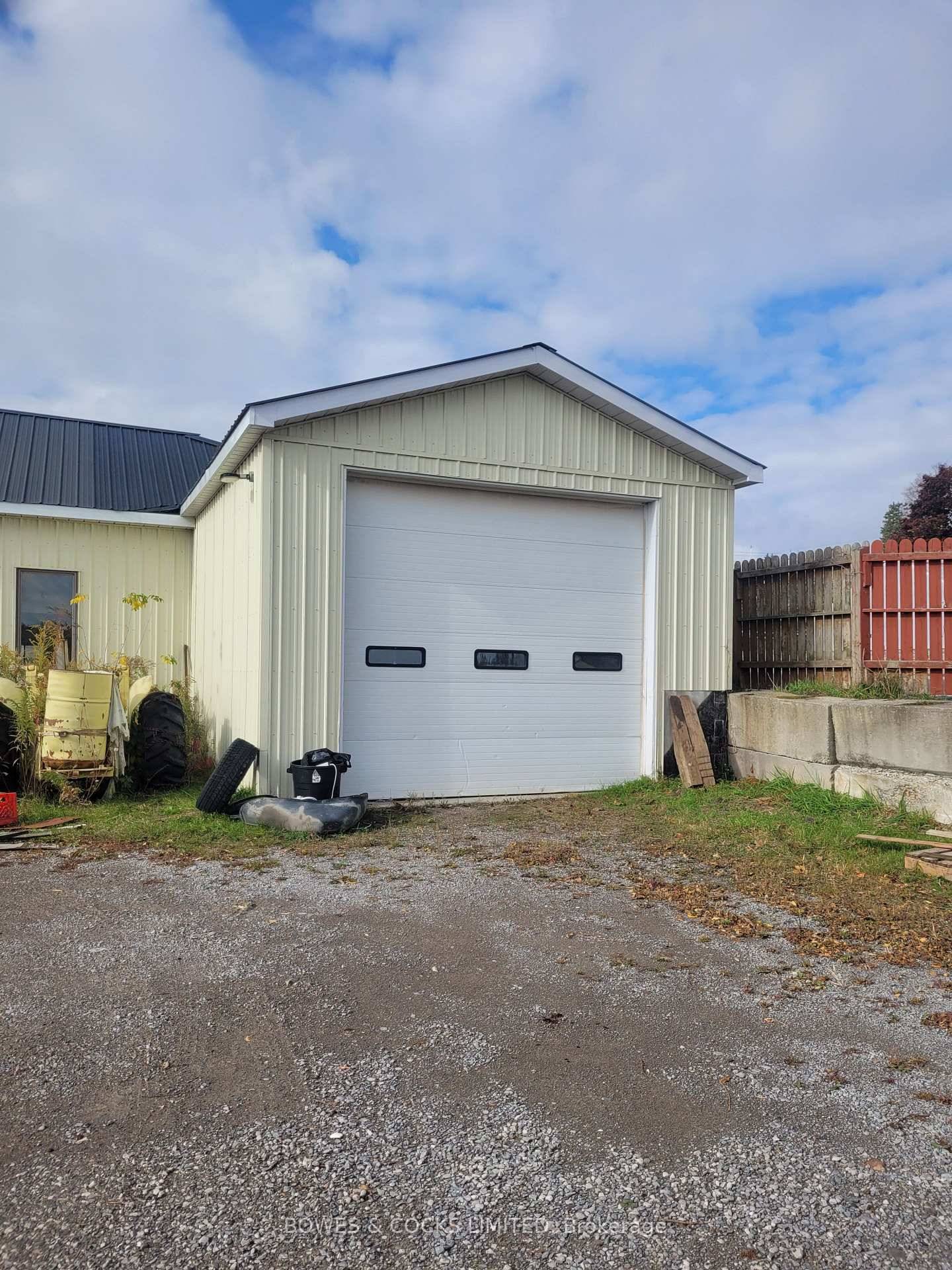 1200 square foot double bay shop with 50 ft x 100 ft fenced storage impound.
