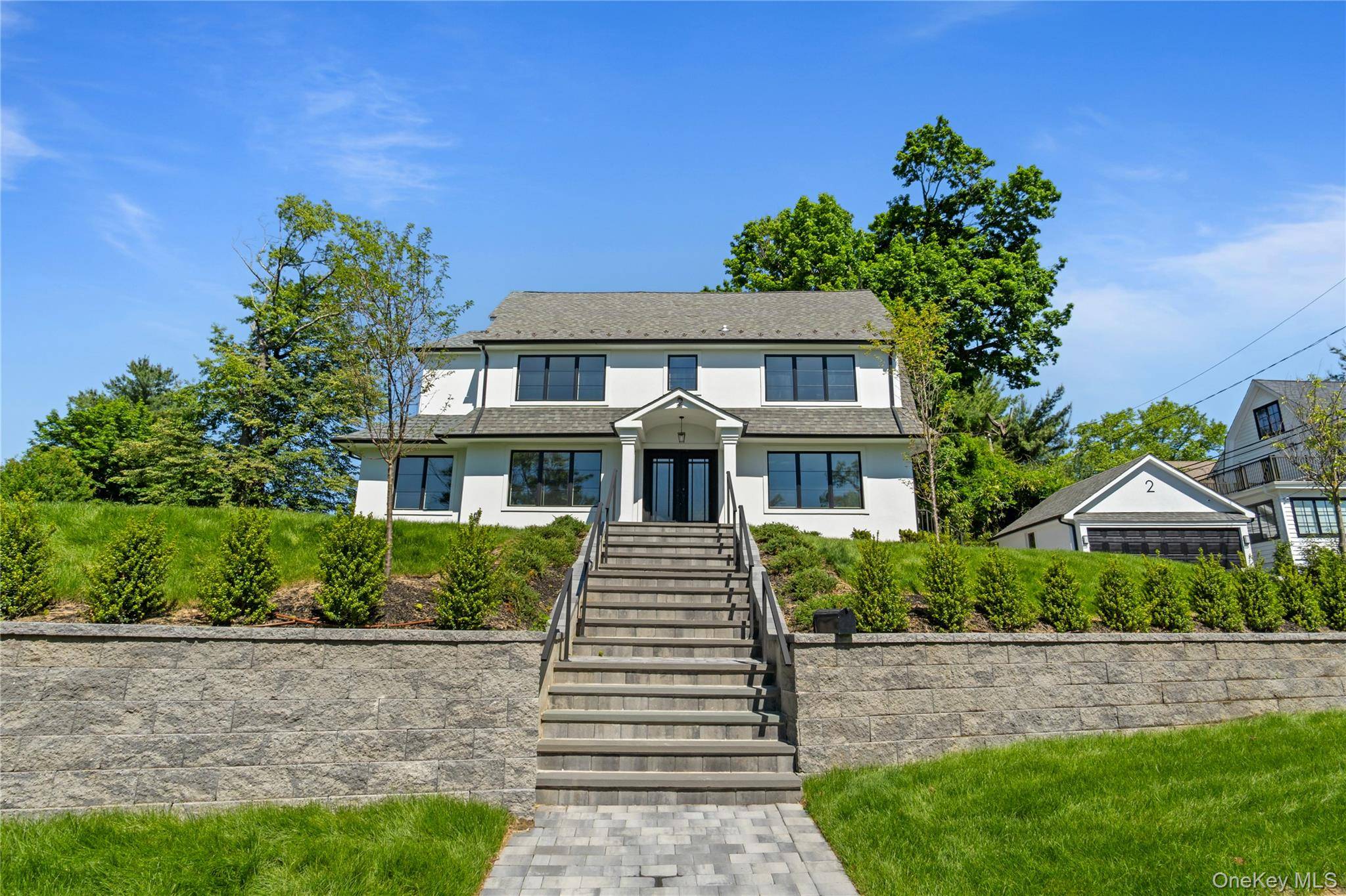 Discover unparalleled luxury in this brand new, sunlit Center Hall Colonial, custom crafted in the coveted Village of Great Neck.