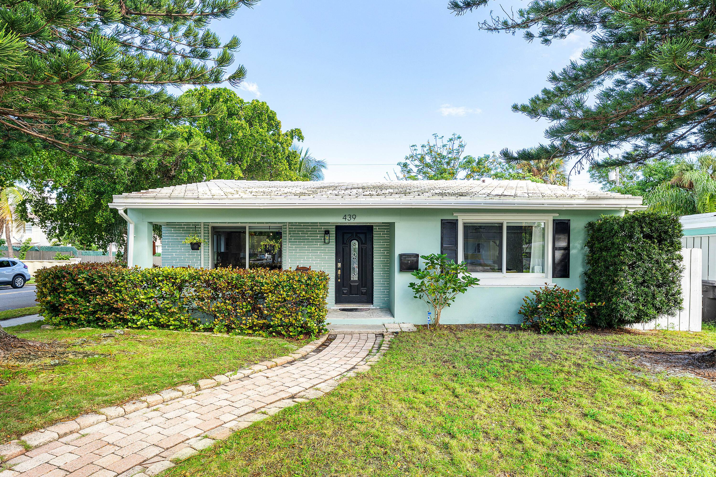 Charming 2 2 corner lot home with detached Garage and beautiful landscaping.