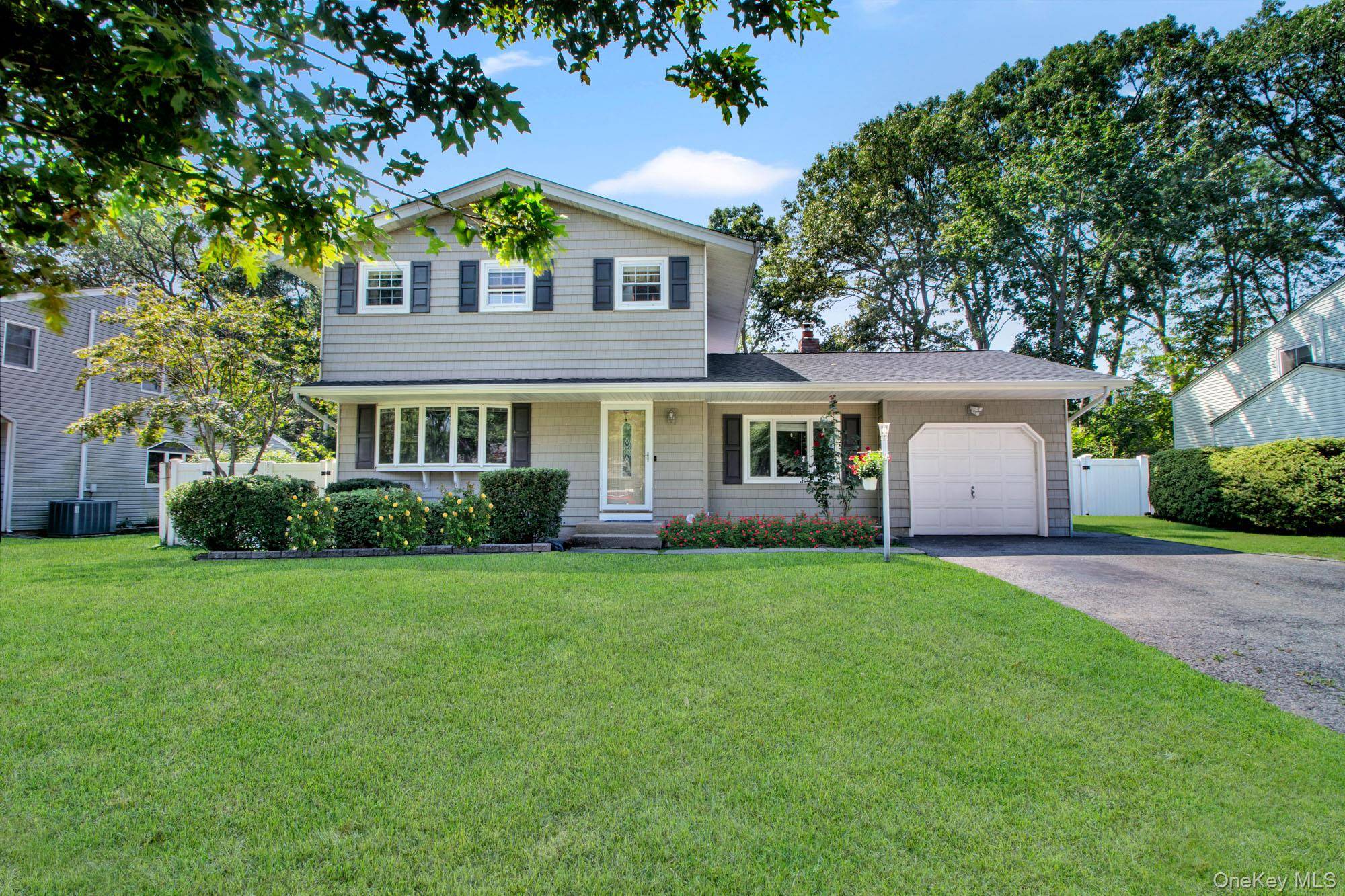 Spacious Four Bedroom Home with In Ground Pool in Smithtown School District.