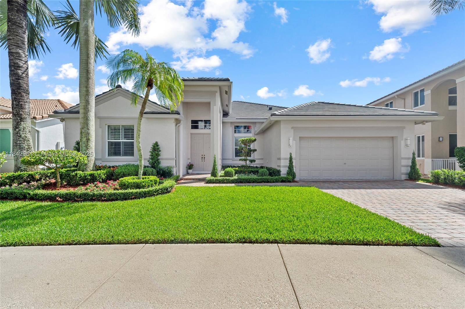 Nestled on a royal palm cul de sac in gated Weston Hills Country Club, this fully renovated 4 bed and den, 3.